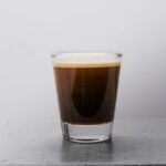 Espresso Shot - clear drinking glass with brown liquid
