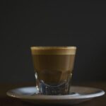 Espresso Crema - coffee filled rock glass on saucer