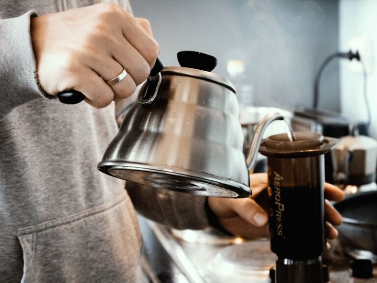 AeroPress - person holding stainless steel teapot