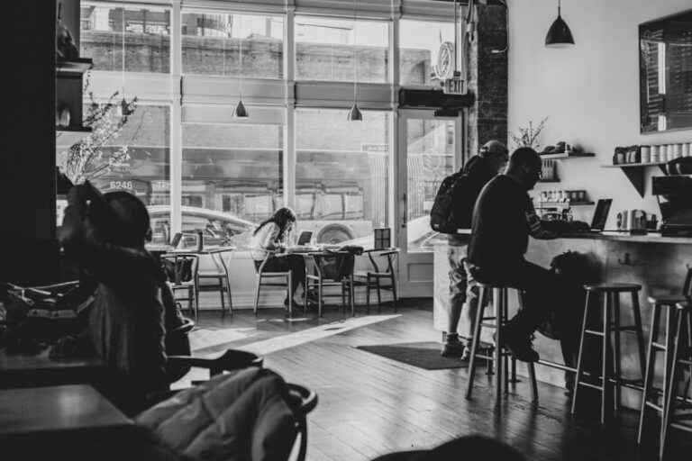Coffeehouse - grayscale photo of people sitting on chair